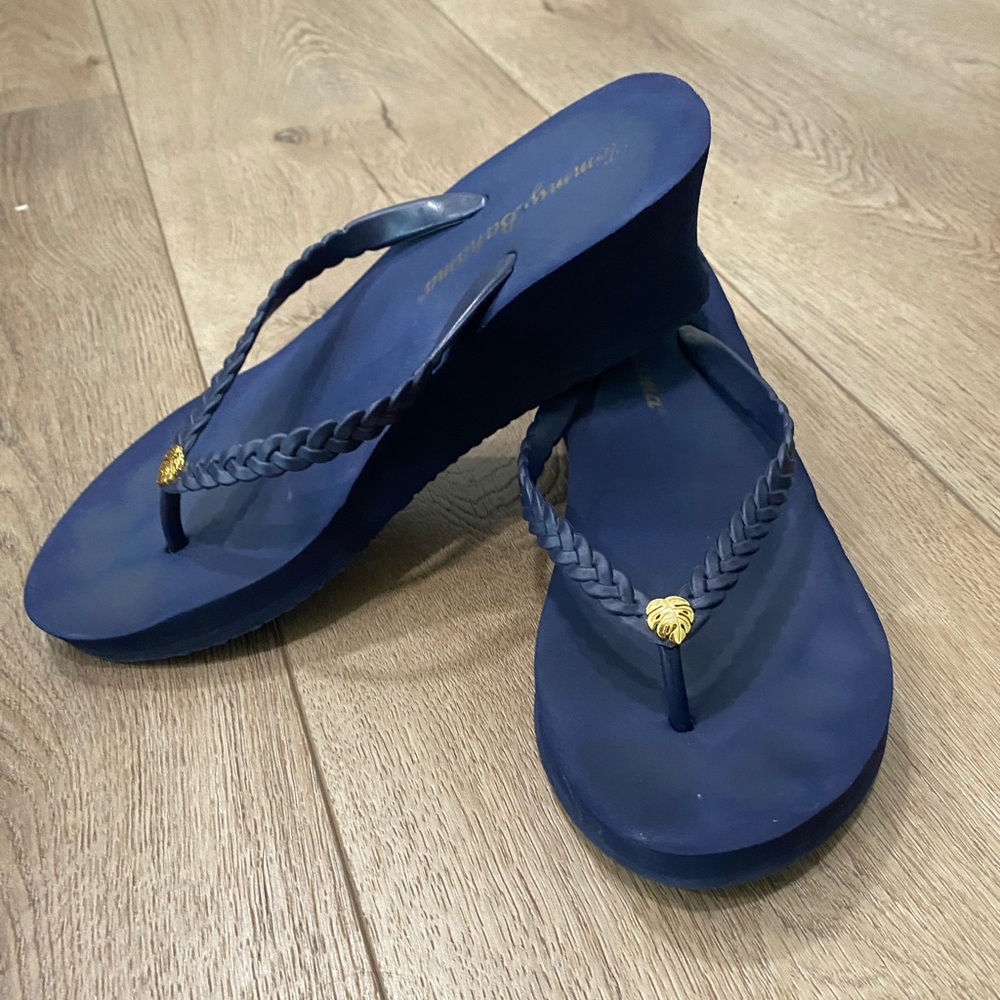 Tommy Bahama Whykiki braided flip-flops featuring a small gold-tone leaf charm